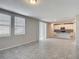 Bright living area with tile floors and sliding glass doors, flowing into an open floor plan with recessed lighting at 596 Sun Warbler Way, St Cloud, FL 34771