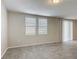 Well-lit, open living space with tile floors and large windows, offering a bright and airy atmosphere at 596 Sun Warbler Way, St Cloud, FL 34771