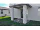 An inviting outdoor living space with covered patio and sliding glass door access to the home's interior at 596 Sun Warbler Way, St Cloud, FL 34771