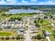 Expansive aerial view showcases a well-planned community near a serene lake, offering picturesque scenery and neighborhood charm at 5967 Churchill Square Way, Groveland, FL 34736