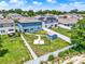 Aerial view of the backyard featuring a playground, shed and well-maintained lawn at 5967 Churchill Square Way, Groveland, FL 34736