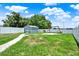 Fenced backyard features a storage shed and playground area at 5967 Churchill Square Way, Groveland, FL 34736