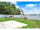 Backyard featuring a wooden swing set, a concrete patio and green grass at 5967 Churchill Square Way, Groveland, FL 34736