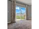 View of the backyard through sliding glass doors at 5967 Churchill Square Way, Groveland, FL 34736