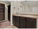 Bathroom features tiled floor, double vanity, and walk in closet at 5967 Churchill Square Way, Groveland, FL 34736