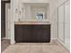 Bathroom featuring double vanity with dark cabinets and glass shower at 5967 Churchill Square Way, Groveland, FL 34736