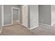 Neutral bedroom with plush carpeting and a door leading to a hallway and additional room at 5967 Churchill Square Way, Groveland, FL 34736