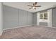 Bedroom featuring soft carpeting, a ceiling fan, and a window letting in natural light at 5967 Churchill Square Way, Groveland, FL 34736
