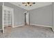 Bedroom featuring gray walls, neutral carpet, and a closet with shelving at 5967 Churchill Square Way, Groveland, FL 34736