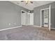 Cozy bedroom with neutral walls, plush carpeting, and a closet ready for customization at 5967 Churchill Square Way, Groveland, FL 34736