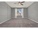 Bedroom featuring a ceiling fan and window with white drapes at 5967 Churchill Square Way, Groveland, FL 34736