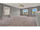 Spacious bonus room with neutral carpet, gray walls and bright windows at 5967 Churchill Square Way, Groveland, FL 34736