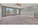 Bonus room features neutral carpet and a view of the neighborhood at 5967 Churchill Square Way, Groveland, FL 34736