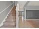 Bright entryway featuring tile flooring, a staircase, and an open view to the backyard at 5967 Churchill Square Way, Groveland, FL 34736
