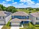 Charming two-story home with a well-manicured front yard and attached garage at 5967 Churchill Square Way, Groveland, FL 34736