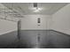Spacious garage with epoxy floors, storage racks, and a water heater at 5967 Churchill Square Way, Groveland, FL 34736