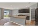 Kitchen with dark cabinets, granite countertops, and a view to the backyard at 5967 Churchill Square Way, Groveland, FL 34736