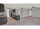 Open-concept kitchen with a large island and stainless steel appliances overlooking the living area at 5967 Churchill Square Way, Groveland, FL 34736