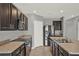 Modern kitchen features stainless steel appliances, granite countertops, and plenty of storage at 5967 Churchill Square Way, Groveland, FL 34736