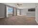 Open living space with a ceiling fan, a view to backyard, and a bar counter at 5967 Churchill Square Way, Groveland, FL 34736