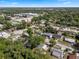 Aerial view of neighborhood with mature trees and a home with a light colored roof at 614 Plum Ln, Altamonte Springs, FL 32701