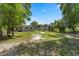 Spacious backyard featuring green grass, mature trees, and partial fencing at 614 Plum Ln, Altamonte Springs, FL 32701