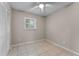 Cozy bedroom featuring neutral walls, ceiling fan, window with blinds, and tile flooring at 614 Plum Ln, Altamonte Springs, FL 32701