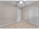Cozy bedroom featuring neutral walls, tile flooring, ceiling fan, and closet at 614 Plum Ln, Altamonte Springs, FL 32701