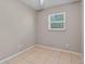 Cozy bedroom featuring tiled floors, a window providing natural light and neutral paint at 614 Plum Ln, Altamonte Springs, FL 32701