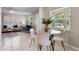 Cozy dining area with a glass-top table and comfortable seating, adjacent to the living room at 614 Plum Ln, Altamonte Springs, FL 32701