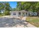 Charming single-story home with a front porch, white pillars, and a concrete driveway at 614 Plum Ln, Altamonte Springs, FL 32701