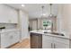 Bright kitchen featuring stainless steel appliances, white cabinetry, and an open layout at 614 Plum Ln, Altamonte Springs, FL 32701