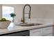 Close-up of kitchen sink with modern faucet, quartz countertop, and stylish cabinetry at 614 Plum Ln, Altamonte Springs, FL 32701