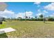 Large backyard with a spacious grass area, offering plenty of room for recreation and relaxation at 616 Griffon Ave, Lake Alfred, FL 33850