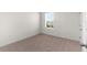 Empty bedroom with plush carpeting and natural light at 616 Griffon Ave, Lake Alfred, FL 33850