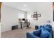 Bright bedroom featuring a desk, certificates, and a comfortable blue sofa, perfect for work or relaxation at 616 Griffon Ave, Lake Alfred, FL 33850