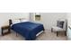 Comfortable bedroom with a full-sized bed, chair and plush carpeting at 616 Griffon Ave, Lake Alfred, FL 33850