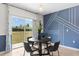 Chic dining area with modern lighting, adjacent to a sliding glass door leading to the backyard at 616 Griffon Ave, Lake Alfred, FL 33850