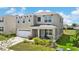 Attractive two-story home with a covered front porch, a two-car garage and lush landscaping at 616 Griffon Ave, Lake Alfred, FL 33850