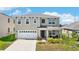Charming two-story home with a two-car garage, covered porch and manicured landscaping at 616 Griffon Ave, Lake Alfred, FL 33850