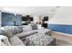 Open-concept living room with a large sectional sofa, connecting to the kitchen and dining areas at 616 Griffon Ave, Lake Alfred, FL 33850