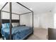 Spacious bedroom featuring a stylish four-poster bed and neutral decor at 616 Griffon Ave, Lake Alfred, FL 33850