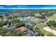 Aerial view featuring the community's clubhouse, pool, tennis courts, golf course, and lovely surrounding neighborhood at 6161 Blakeford Dr, Windermere, FL 34786