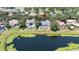 Aerial view of the home with a pond in the backyard, situated among lush trees and landscaping at 6161 Blakeford Dr, Windermere, FL 34786
