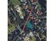An aerial view of the community showcases the roads and tennis courts in a leafy neighborhood near Golden Bear Club at 6161 Blakeford Dr, Windermere, FL 34786