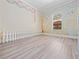bedroom features wood-look flooring, mural and a window providing natural light at 6161 Blakeford Dr, Windermere, FL 34786
