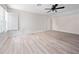 Light-filled bedroom with a ceiling fan, neutral walls, and wood-look flooring at 6161 Blakeford Dr, Windermere, FL 34786