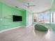 Vibrant green bedroom features large windows with bench, and modern ceiling fan at 6161 Blakeford Dr, Windermere, FL 34786