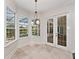 Bright breakfast nook featuring tile floors, large windows, and access to a covered patio area at 6161 Blakeford Dr, Windermere, FL 34786