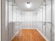 Walk-in closet with custom shelving and wooden floors at 6161 Blakeford Dr, Windermere, FL 34786